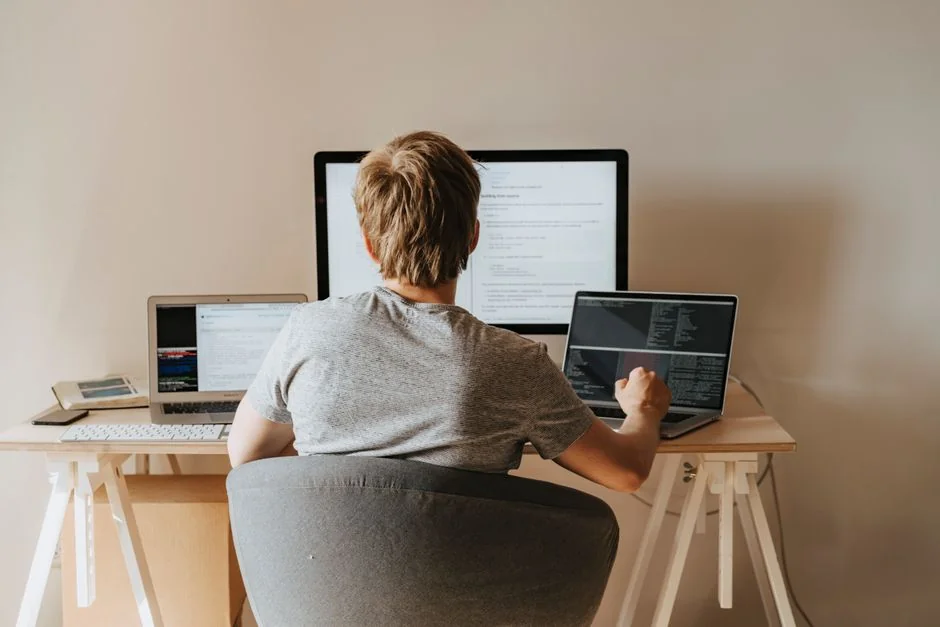 Group of designers collaborating in modern office space with computer.